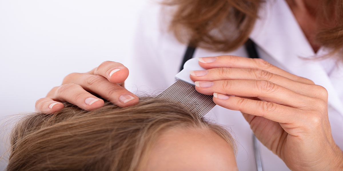 mother combin lice from girls head